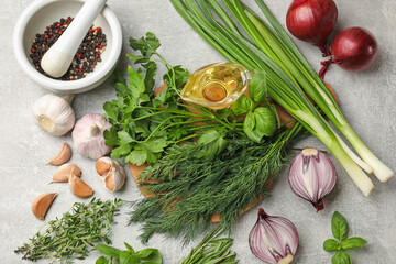 Different herbs and spices on grey table, flat lay