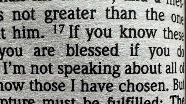 Inspirational video showing the word &ldquo;Blessed&rdquo; at the center of the screen, while background images of Bible pages slowly change. A spiritual and calming motion clip ideal for worship visuals.