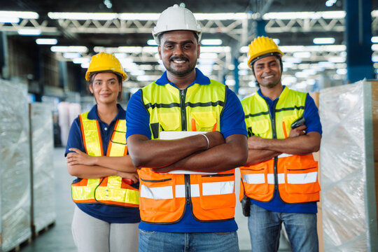 Diverse workfoce team black men,woman factory worker wear safety helmet, safety vest use tablet for industrial warehouse job.Teamwork efficient success modern logistic manufacture operation management