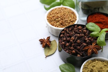 Different aromatic spices on white table, closeup. Space for text