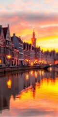 Obraz premium Sunset Reflection Over Historic Canal and Buildings in Bruges