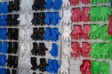Fototapeta premium Display of colorful gloves in different materials at a trade show