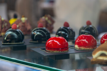 Colorful dessert display in a pastry shop during afternoon hours
