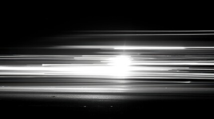Abstract light painting of streaking car headlights on a highway captured in monochrome