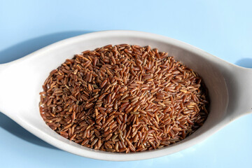 Healthy uncooked raw red or brown rice. High quality photo