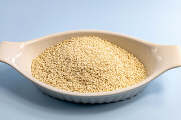 Sesame seeds in a white bowl. High quality photo