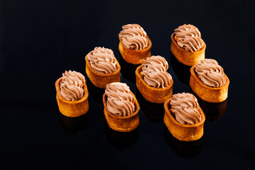 Dessert of dough, nut tartlets covered with a layer of caramel. Tartlet with caramelized nuts...
