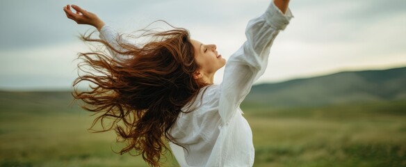 The woman embracing freedom with flowing hair in a beautiful natural landscape.