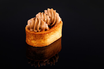 Tartlet with caramelized nuts isolated on black. Tasty dessert. Caramel tartlet, caramelized...