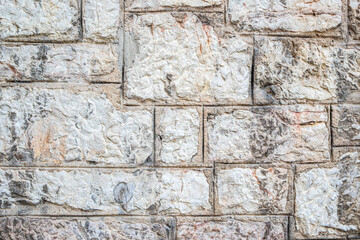 Close-Up of a Textured Stone Wall with Light and Neutral Tones