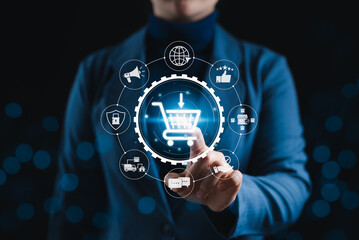 Online shopping and e-commerce technology internet concept. A person interacts with shopping cart icon surrounded by e-commerce and internet related symbols, representing online retail technology.