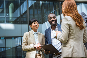 caucasian businesswoman with multicultural clients outdoor