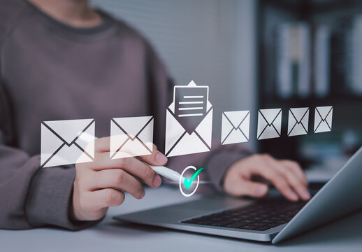 Email Marketing Communication and Inbox Management Concept. Woman interacts with email icons while working on laptop, symbolizing email marketing, communication technology, digital message management,