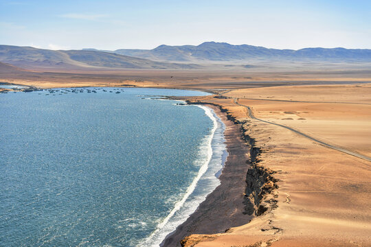 A breathtaking view of Playa Roja, known for its unique red sand and the dramatic cliffs in Paracas Natural Reserve. - Powered by Adobe