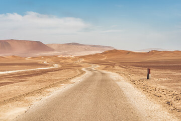 Winding road through the Desert of Paracas National Reserven in Peru