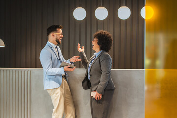 diverse businesswoman and businessman discuss at the company reception
