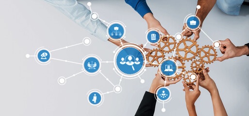 Hands of diverse individuals come together holding gears, surrounded by icons that illustrate...