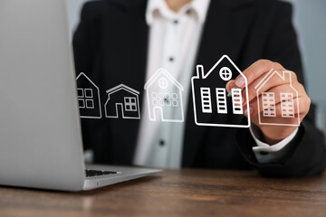 Real estate agent touching house icon on virtual screen at table, closeup. Search for housing