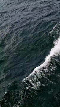 Waves of lake water from the boat with splashes competing with each other. Lake Toba with the side of the boat crossing from Tomok port to Parapat port, North Sumatra, Indonesia.