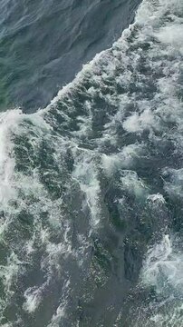 Waves of lake water from the boat with splashes competing with each other. Lake Toba with the side of the boat crossing from Tomok port to Parapat port, North Sumatra, Indonesia.