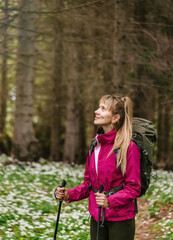 Woman Hiking through Spring Forest Glade