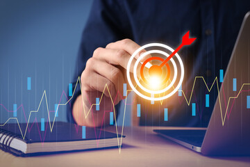 Targeting. Businessman touching aim with arrow on virtual screen at table, closeup