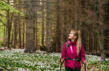 Woman Walking through Blooming Forest Glade