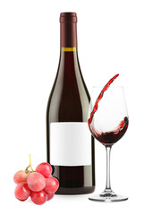 Luxurious red wine in bottle with blank label, glass and grapes isolated on white