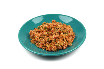 Traditional Turkish bulgur salad Kisir close-up on a plate on the table. Horizontal view from above