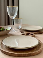 Table Setting with Wooden Placemats, Plates, and Glasses