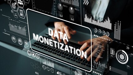 Professional hands typing on laptop keyboard with data monetization graphics and analytics in...