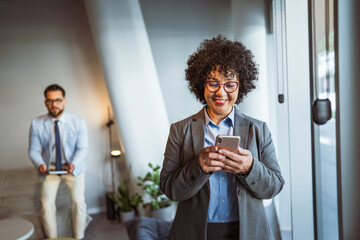 mature african american businesswoman use mobile phone at workplace