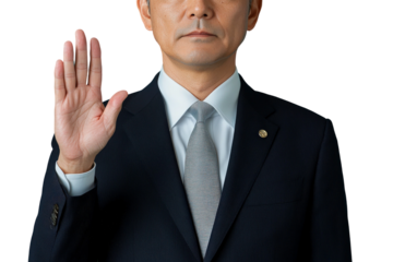 Business professional with raised hand giving an oath or promise, formal attire in a studio setting, serious expression with isolated background