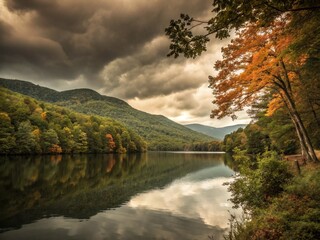 Obraz premium Serene autumn mountain landscape with a reflective lake and vibrant trees under a clear sky
