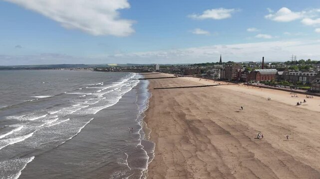 Aerial shot of wide Portobello Beach in Edinburgh, Scotland, United Kingdom