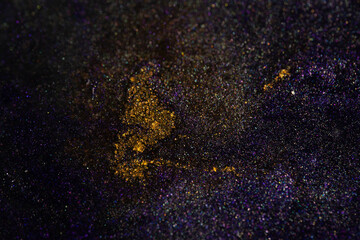 Yellow glitter splash on purple shimmer texture