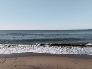 Fototapeta premium Calm ocean waves on a sandy beach