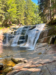 Mumlava Waterfall in Czechia, powerful cascade in forested mountains