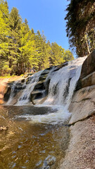 Mumlava Waterfall in Czechia, powerful cascade in forested mountains