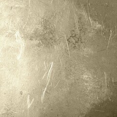 Metallic gold-toned grunge texture with distressed scratches, worn surface marks, and vintage shine. Ideal for luxury designs, backgrounds, posters, packaging, and digital art projects.