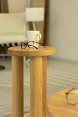 Eyeglasses placed on a wooden table surface
