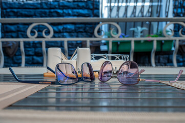 Eyeglasses lie on table in a street cafe.