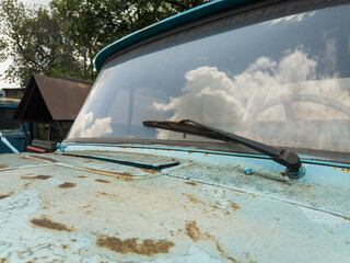 Old, rust-eaten trucks rest on a weed-choked wasteland, definitively out of service.