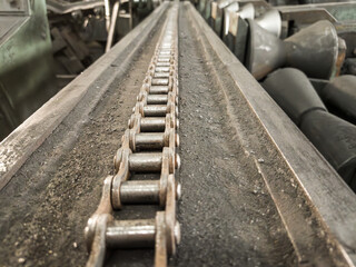 Close-up of a heavy chain used to secure graphite electrodes during nipple cutting.