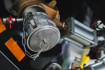 Close-up of bronze valves and pneumatic actuators mounted on industrial machinery. The setup...