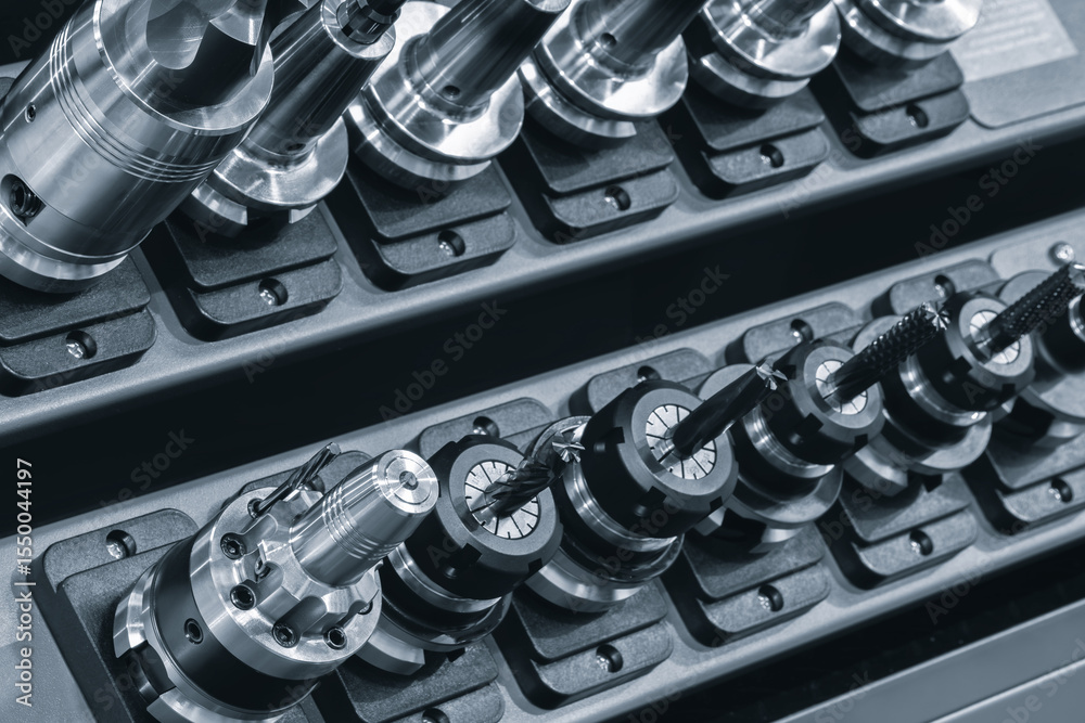 Poster a row of metal tools, milling cutters and drills, are lined up on a shelf. tools are all different s