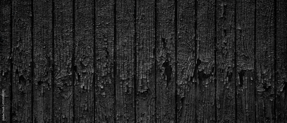 Poster wooden fence as dark black texture background. fence is old and has a lot of peeling paint and has r