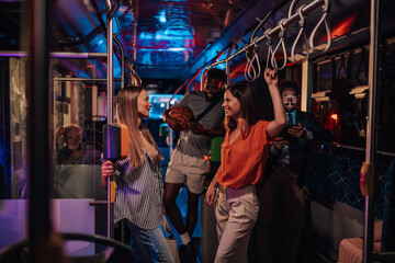 Young people having fun on night bus ride