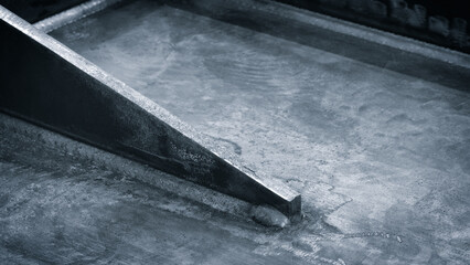 weld seam attaches black metal part to another metal surface, metal welding industrial reliability...