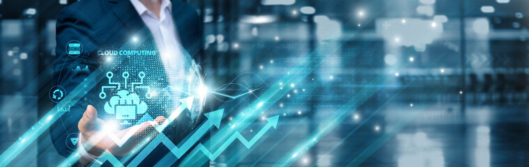 Businessman holding cloud computing services icon and interacting with a global network ecosystem,...